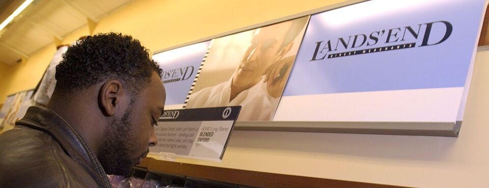 John Green looks for Lands' End dress shirts while shopping at a Sears store in Chicago, on